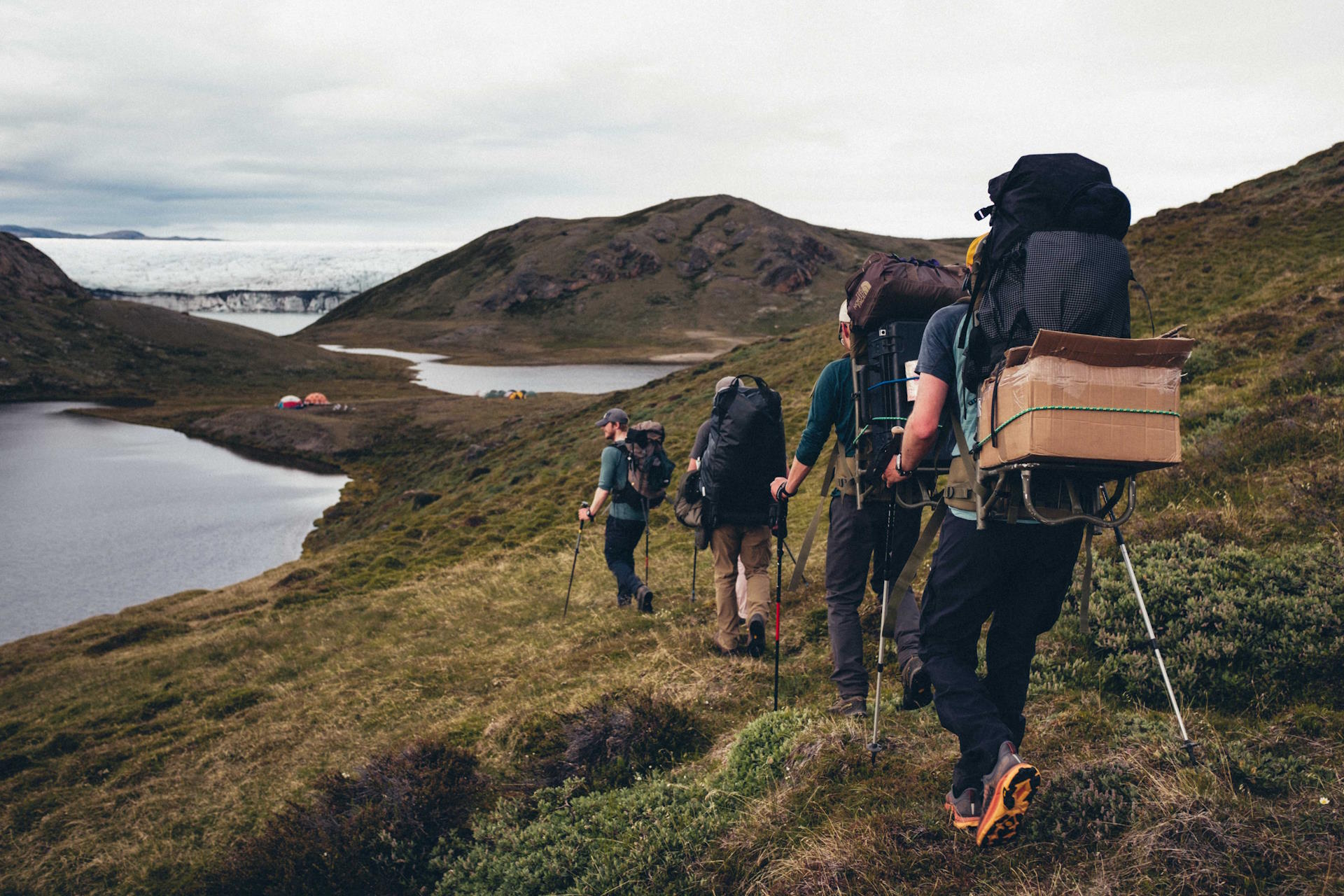 Packing supplies and equipment into base camp. Isunnguata Sermia looms on the horizon. (Photo: Joe Reynolds)